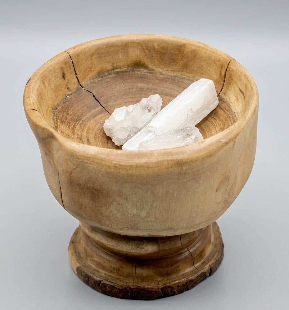 A footed vessel turned in light, figured wood, the bark left intact at the foot to ground the piece on the trunk it came from.